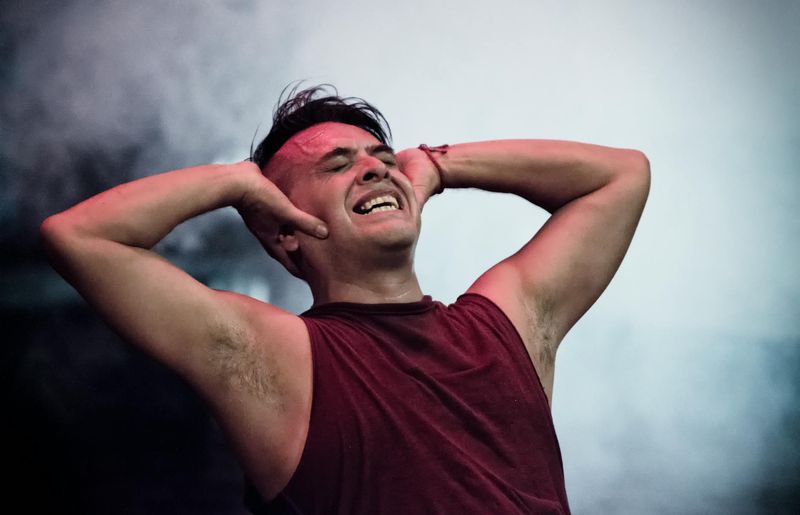 Man in a dynamic strength pose showing muscle engagement.